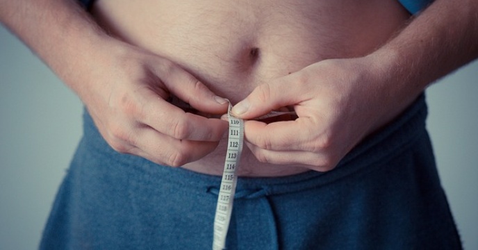 Man measuring his waistline