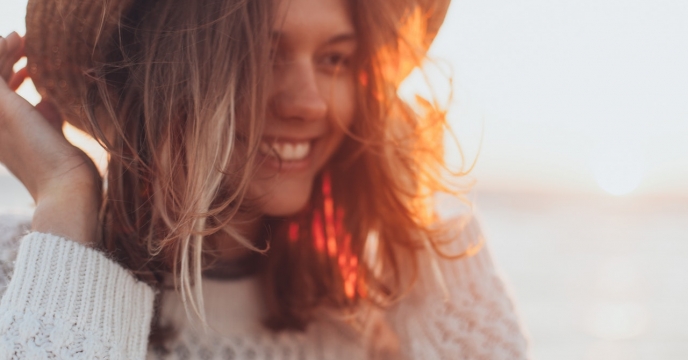 A woman smiling during the golden hour