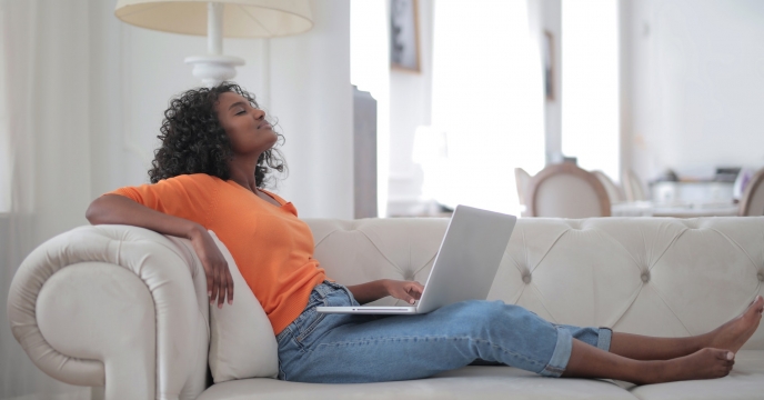 Woman sitting on the couch with her laptop